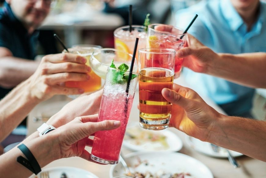 Group of people saying cheers with drinks